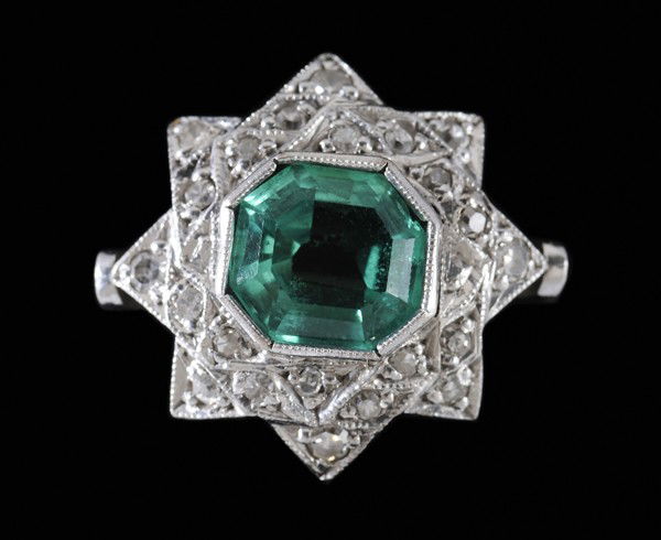 Emerald and Diamond Ring: central faceted eight-sided mixed-cut emerald, estimated weight 1.88 cts., accented with 23 single-cut diamonds, total estimated weight .20 cts., 18 kt. white gold star-form mount, size 6-1/4; insuran
