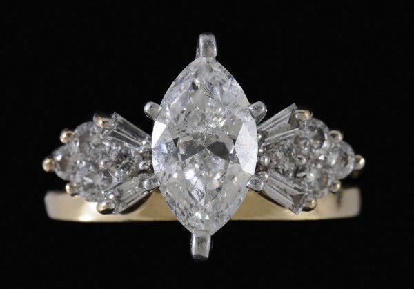 Diamond Bridal Set: central marquise diamond, estimated weight 1.50 cts., color H to I, clarity I-1, joined band accented with 12 round brilliant and baguette-cut diamonds, total estimated weight .50 cts., size 5-1/4; in