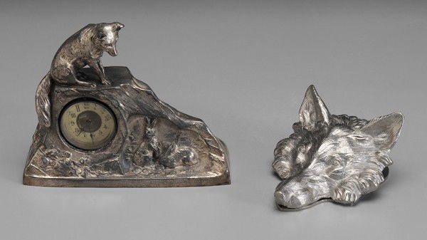 Two Silver-Plated Foxes: clock in form of rock with fox on top and rabbits at base, unmarked, 6-1/2 x 7-1/2 x 2-3/4 in., [works later, loss to plate;] contemporary paper clamp in the form of fox head, unmarked, 3 x 6 x 4-3/4