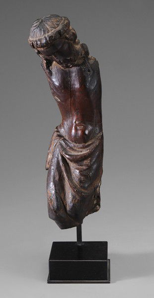 German School: (possibly 16th century), Torso of Christ, a portion of a crucifix, 12-3/4 in. without stand, 15-3/4 in. with wood and metal stand, splits, lacking arms, legs, cross Provenance: A New York Collection