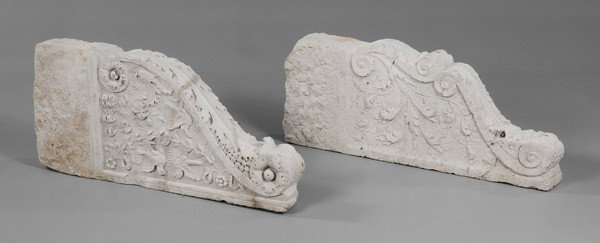 Two Similar Renaissance Style Relief-: Carved Limestone Brackets, Italian, probably 18th or 19th century: large forms, one with relief-carved lovebirds, swags and foliage on one side, verso with scroll and rosette carving, [break and repai