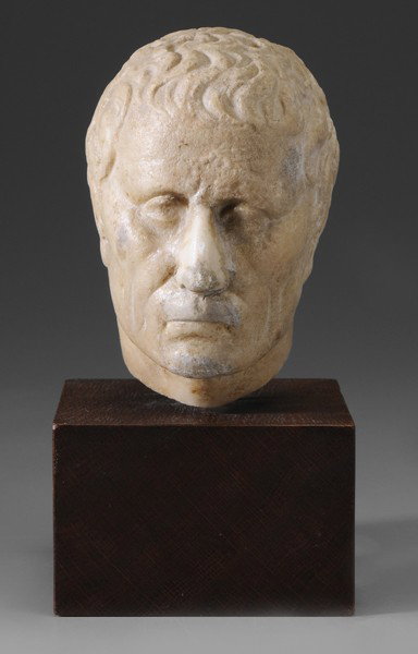 Italian School: (Roman, 1st century style), Portrait Head of a Man, possibly Julius Caesar, carved marble, 6-3/8 x 3-3/4 x 4-7/8 in., 8-1/2 x 4-1/2 x 5-1/2 in. with new wood stand, repairs at nose, upper lip and chee