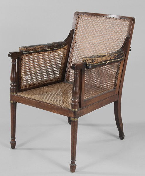 Regency Mahogany Campaign Chair: British, 19th century, collapsible form with caned back, seat and arm supports, arms fitted with original leather padding, 37 x 25-1/2 x 29 in., rear legs ended out approximately 4 in., leather arms b
