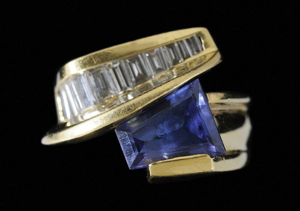 Tanzanite and Diamond Ring: tanzanite, estimated weight 2.72 cts., channel set with eleven baguette-cut diamonds, estimated weight .50 cts., color H-I, clarity VS-SI, 18 kt. gold contemporary mount, gross weight 13.1 grams, size