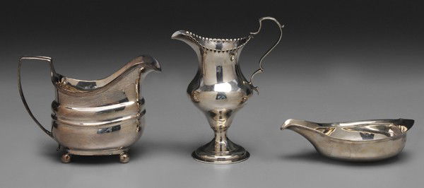 Three Pieces George III English Silver: London: urn-form cream pitcher, partial maker mark, possibly Hester Bateman, 1784, 5-1/4 x 4 x 2-1/2 in.; creamer with ribbed middle, ball feet, marks for 1809, 3-3/4 x 5-1/2 x 2-3/4 in., [repairs to