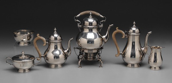 Six-Piece Gorham Sterling Tea Service: American, 20th century: pear-shaped Colonial style, stepped ball finials, wooden scroll handles, 12-3/4 in. hot water kettle with matching coffeepot, teapot, covered sugar, creamer, waste, monograms, 