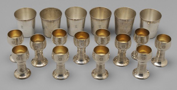 Eighteen Sterling Cocktail Accessories: American, 20th century: six shot glasses, Durgin, 2-3/8 in.; twelve Danish style cocktail goblets, gilt interiors, Lunt, 2-3/4 in., monograms, 25.55 oz.T., small dents, light scratches Provenance: Pri