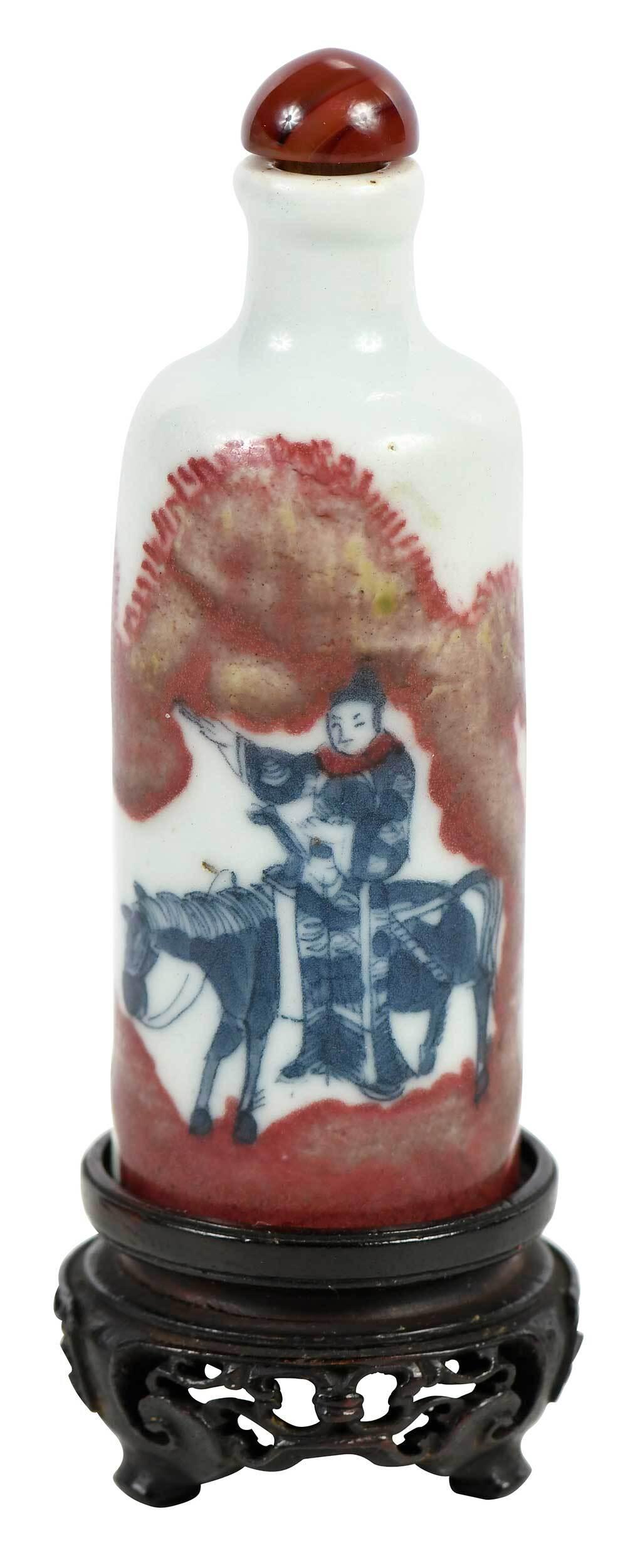 Chinese Porcelain Snuff Bottle with Jade Finial: Qing dynasty, with six character reign mark of the Yongzheng emperor, underglaze blue and red design of figure on horseback and attendant, bone spoon, carved wood stand, 3-1/4 in. Note: Wilhelmine Kir