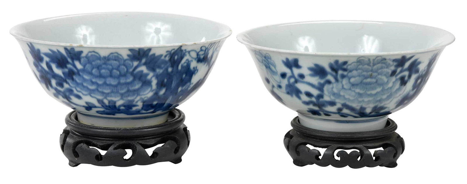 Two Chinese Underglaze Blue Peony Bowls: possibly Ming dynasty, each with floral decoration and banding, carved wood stands, both approximately 2-3/4 x 6-1/2 in. Note: William Joseph Roache and his family moved from Australia to Hong Kong in