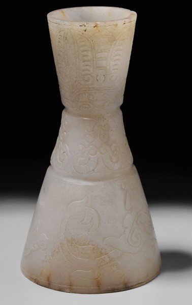 Jade Stemmed Wine Cup: Chinese, archaistic incised dragons, ram's horns and cicadas, gray/white with russet patches, 4-3/8 in., minor chips to foot rim, top rim rough Provenance: Private Collection