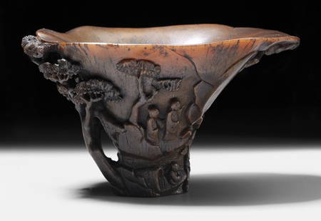 Carved Rhinoceros Horn Libation Cup: Chinese, tapering elliptical form of dark toffee color, dynamic but fine high relief carving with areas of openwork depict the theme of the "Red Cliffs", no seal mark, 3-1/2 x 6 x 3-7/8 in., chipped r