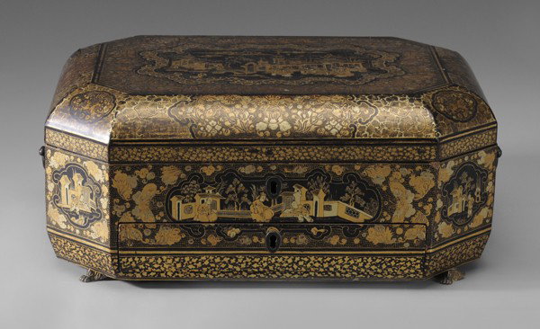 Chinese Export Work Box: first quarter 19th century, canted rectangular form with hinged lid, drawer, metal handles and diminutive metal dragon-claw feet, gilt lacquer decoration of court scenes in scrolled cartouches, scene 
