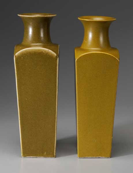 Two Teadust Porcelain Vases: (Chinese, square-section vases with rounded shoulders: one olive with yellow flecks, glaze thinning to white at edges, 18-1/8 in., [minor flaws, rim with repairs;] one yellowish-olive with brown fleck