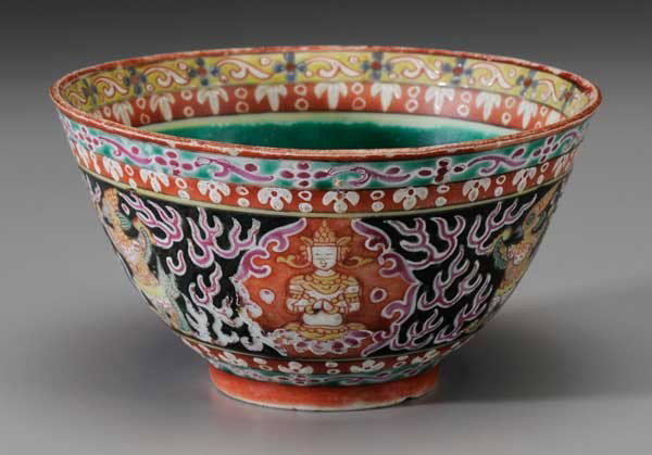 Polychromed Glazed Porcelain Bowl With: Buddhist Motifs probably Thailand, stylized Buddha and dragon figures, 3 x 5-5/8 in., rim crack, surface pitting and wear, glaze losses and wear throughout especially to pink, other rim flaws Provenan