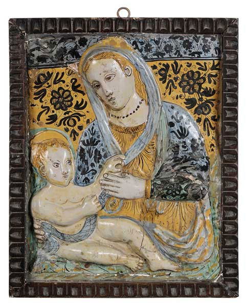 Majolica Votive Plaque, Madonna and: Child Italian, 19th century or earlier, polychrome tin-glazed earthenware with mother and child in relief against indigo-colored patterns of flowers, 17 x 13-1/4 in., in wooden frame 19 x 15-1/2 in.,