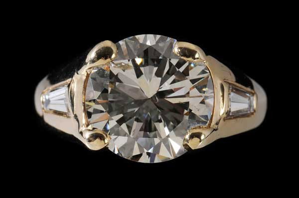 5.12 Ct. Diamond Ring: round brilliant-cut diamond, color J, clarity I1, with two baguettes, total estimated weight (baguettes) .50 cts., color H-J, clarity VS, 14 kt. yellow gold mount, total gross weight 8.7 grams, size 6
