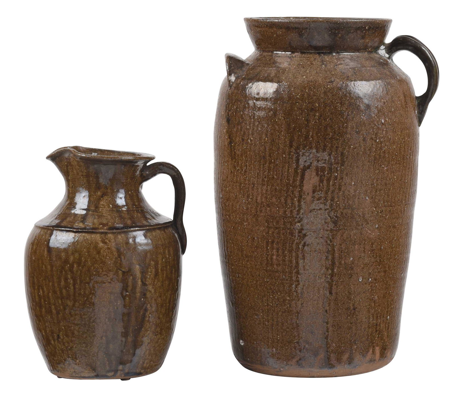 Two Pieces of Rhinehardt Bros. Pottery: (Vale, North Carolina, circa 1930s) runny olive green alkaline glazed pitcher, ridged shoulder, applied strap handle with extended tail, up angled pinched spout, 11-1/2 in.; olive green alkaline glaze