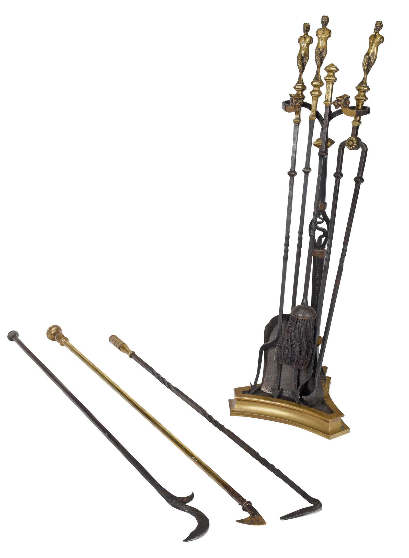 Set of Oscar Bach Attributed Brass and Iron Fireplace Tools: circa 1925, not apparently signed, comprising: brass and iron stand with tiger mask terminals and trifid base, 30-1/2 x 13 x 11-1/2 in.; together with seven assorted brass and iron fire tools, three w