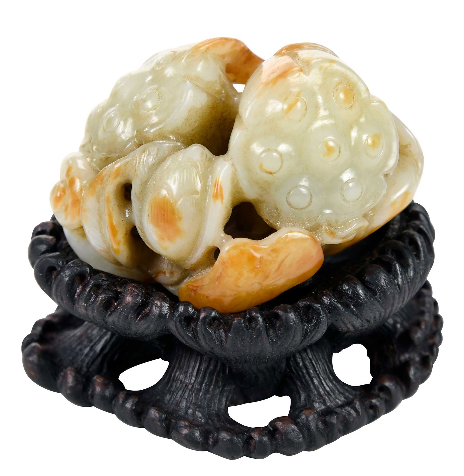 Chinese Carved Jade Lotus and Stand: pale green with russet inclusions, carved lotus pods and openwork stems, 1-1/2 x 2-3/4 x 2-1/4 in.; conforming openwork carved wood stand, 1 x 3 x 2-3/4 in.