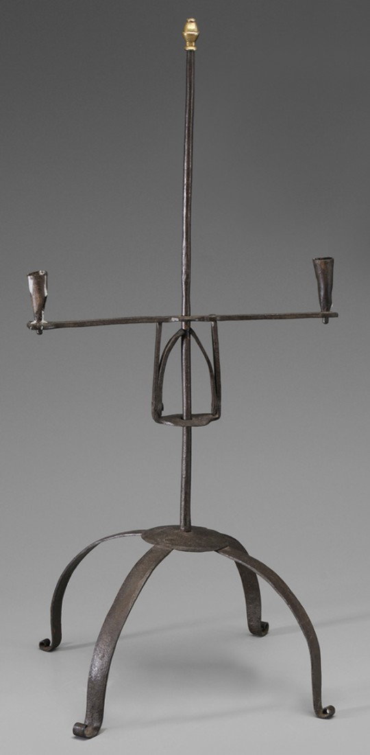 Wrought Iron Candle Stand: American or British, 18th century, on adjustable bridge with two candle sockets, mounted on slightly tapered shaft with brass finial, raised on four scrolled feet, 32-1/4 in., scattered old rust and l
