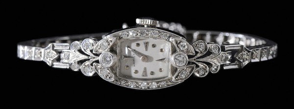 Lady's Diamond and Gold Wristwatch: Hamilton 14 kt. white gold wristwatch accented with approximately 52 round brilliant and single-cut diamonds, estimated combined diamond weight 1.0 ct., color H-J, clarity VS, 22-jeweled movement, gro