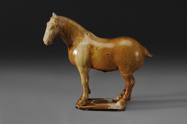 Tomb Figure of Horse: Chinese, Tang Dynasty style, amber glaze, 8 x 9 in., glaze cracks as made Provenance: Estate of the late Patrick H. Booth, Jr., Petersburg, Virginia