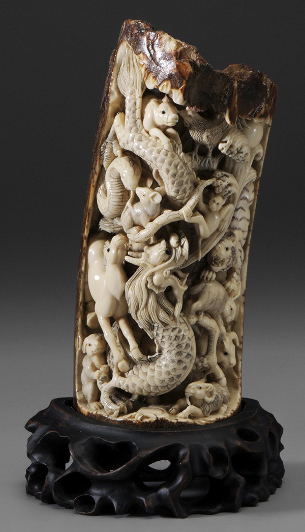 Mammoth Tusk Carving: modern carving with inking, twelve animals of the Zodiac, 6-1/4 in., with associated stand, good condition Provenance: Estate of the late Dr. Joseph Chandler Battaile, Sr., Memphis, Tennessee