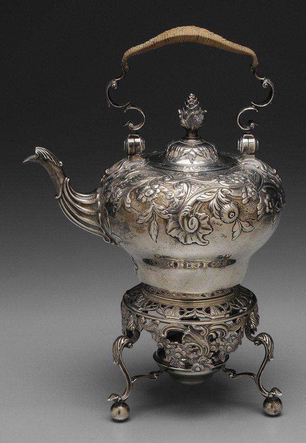 English Silver Hot Water Kettle: London, 1903, scroll, shell and floral decoration, wicker-wrapped handle, ball feet, marks for James Wakely & Frank Wheeler, heraldic device, .925 fine, 56.87 oz.T., 14-1/2 x 9-1/2 x 7 in., good condi