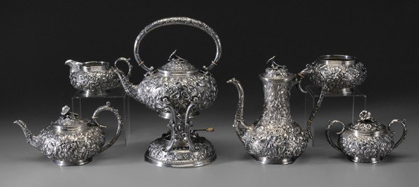 Six-Piece Sterling Kirk Repoussé Tea: "Service American, 1896-1924, all-over floral decoration, flower bud finial, marks for S. Kirk Son Co., ""103"", base inscribed ""JK/April 27-1905"", 156.21 oz.T., 12-1/2 in. hot water kettle with mat