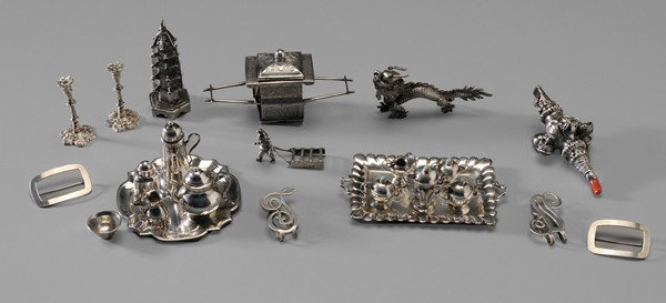 Group of Miniature Sterling Items: 20th century: pair candlesticks; tray; coffeepot; teapot; creamer; tea box; bowl; five-piece Mexican tea service with tray; pagoda; English silver rattle; gnome pulling sled; two clips; two pins; drag