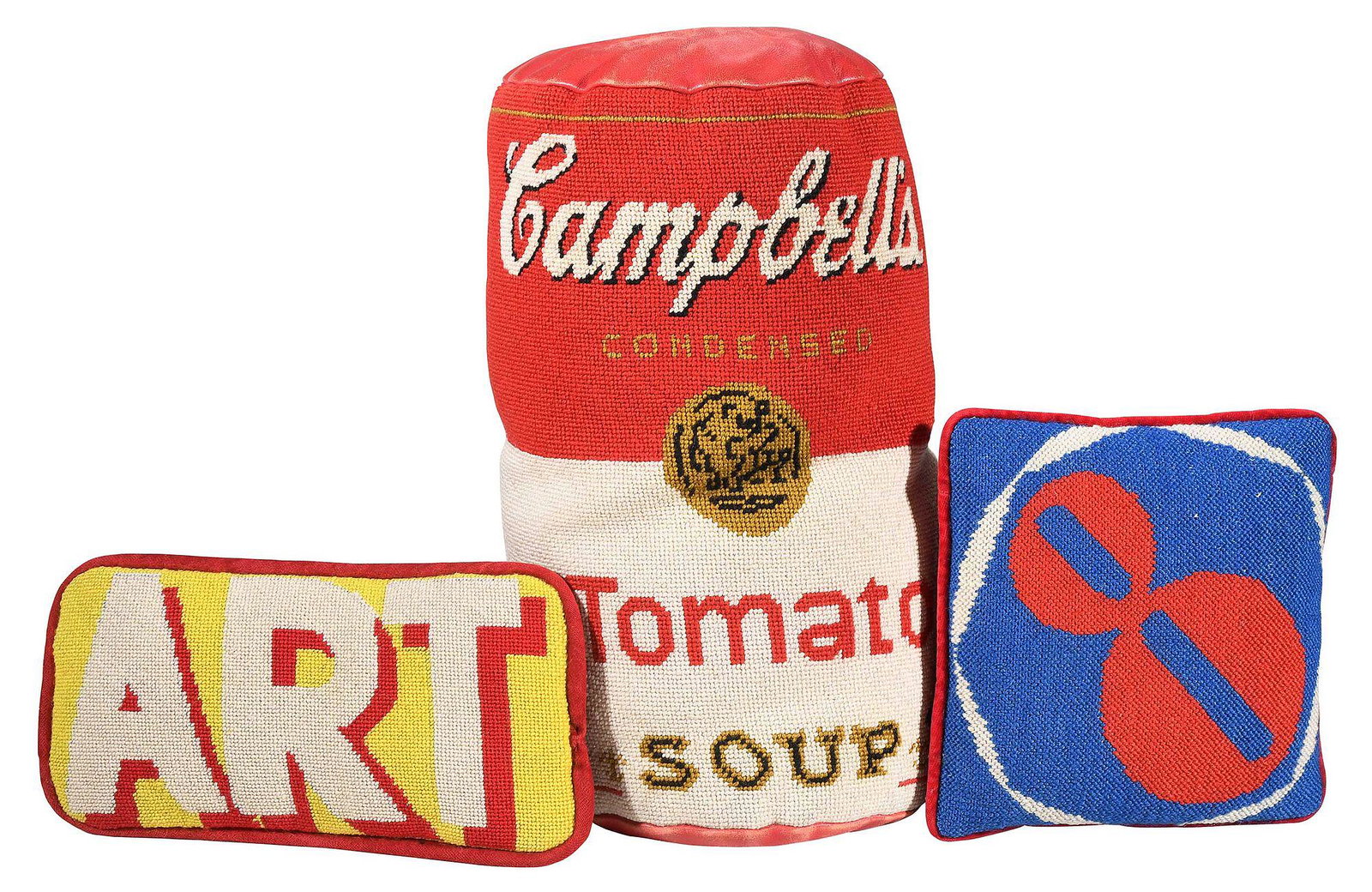 Three Whimsical Pop Art Needlework Pillows: "Campbell's Tomato Soup", needlework and leather; yellow and red "ART" needlework with felt backing; red and blue "8" with felt backing; largest 15-1/2 x 7-1/2 in. Provenance: Collection of Jean and J
