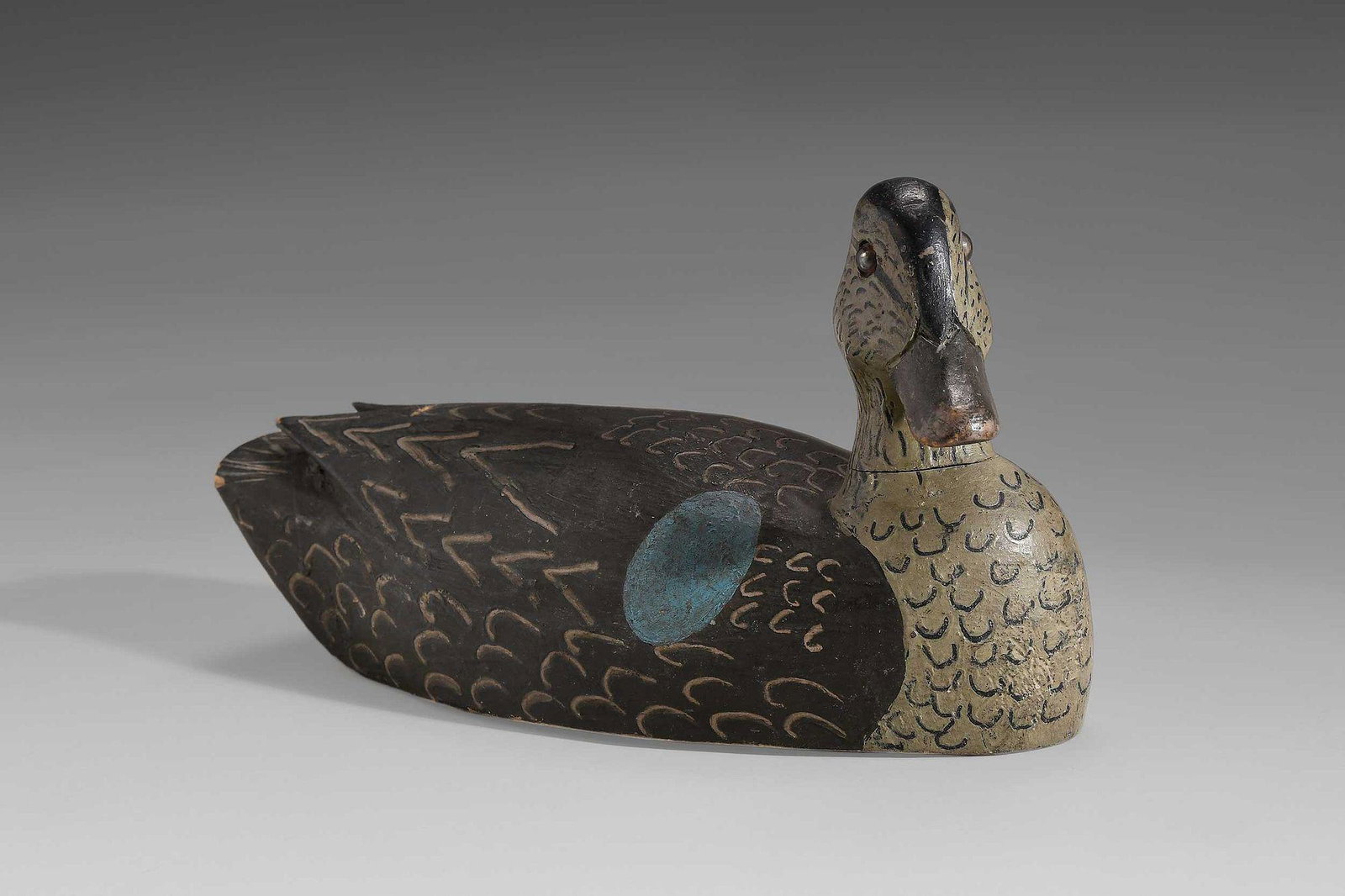 Blue Winged Teal Hen Decoy: unknown maker, flat bottom style with small weight, solid body, turned head, glass eyes, raised wing primaries, incised feather detail, 5 x 10 x 4 in. Provenance: Collection of Jean and Jim Barrow Ple