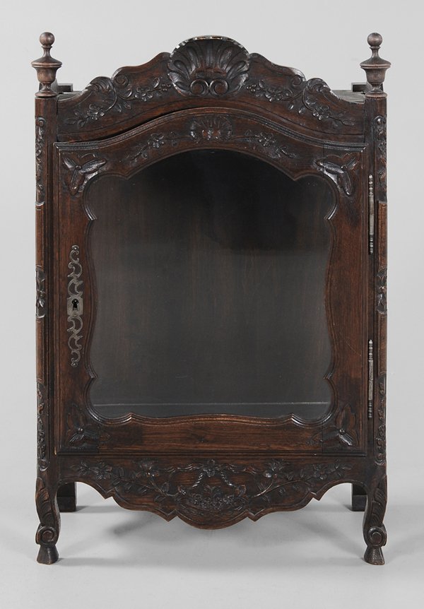 Provincial Louis XV Style Carved Oak: [Panetière] French, 20th century, glazed door with steel hinges and escutcheon, elaborately carved frieze and skirt, 37-1/2 x 24 x 12 in.,