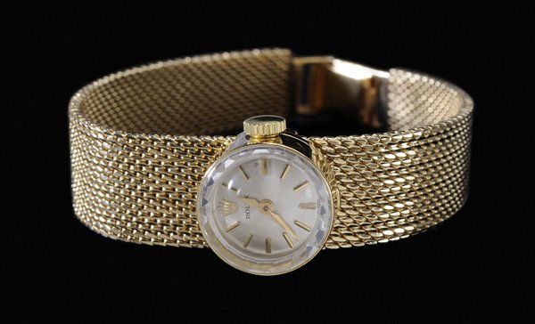 Lady's 18 kt. Gold Wristwatch: sliding raised case, white dial marked "Rolex", movement No. 1400, gold Rolex mesh bracelet, case and bracelet stamped "18K", gross weight 26.3 grams, 6 in., with four leather fashion bands,