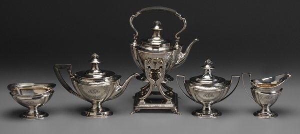 Tiffany Sterling Five-Piece Tea: Service American, 1891-1902, engraved floral decoration, basket of flower finials, wood handles, 13 in. hot water kettle on stand with matching teapot, coffeepot, creamer, covered sugar, waste, marks 