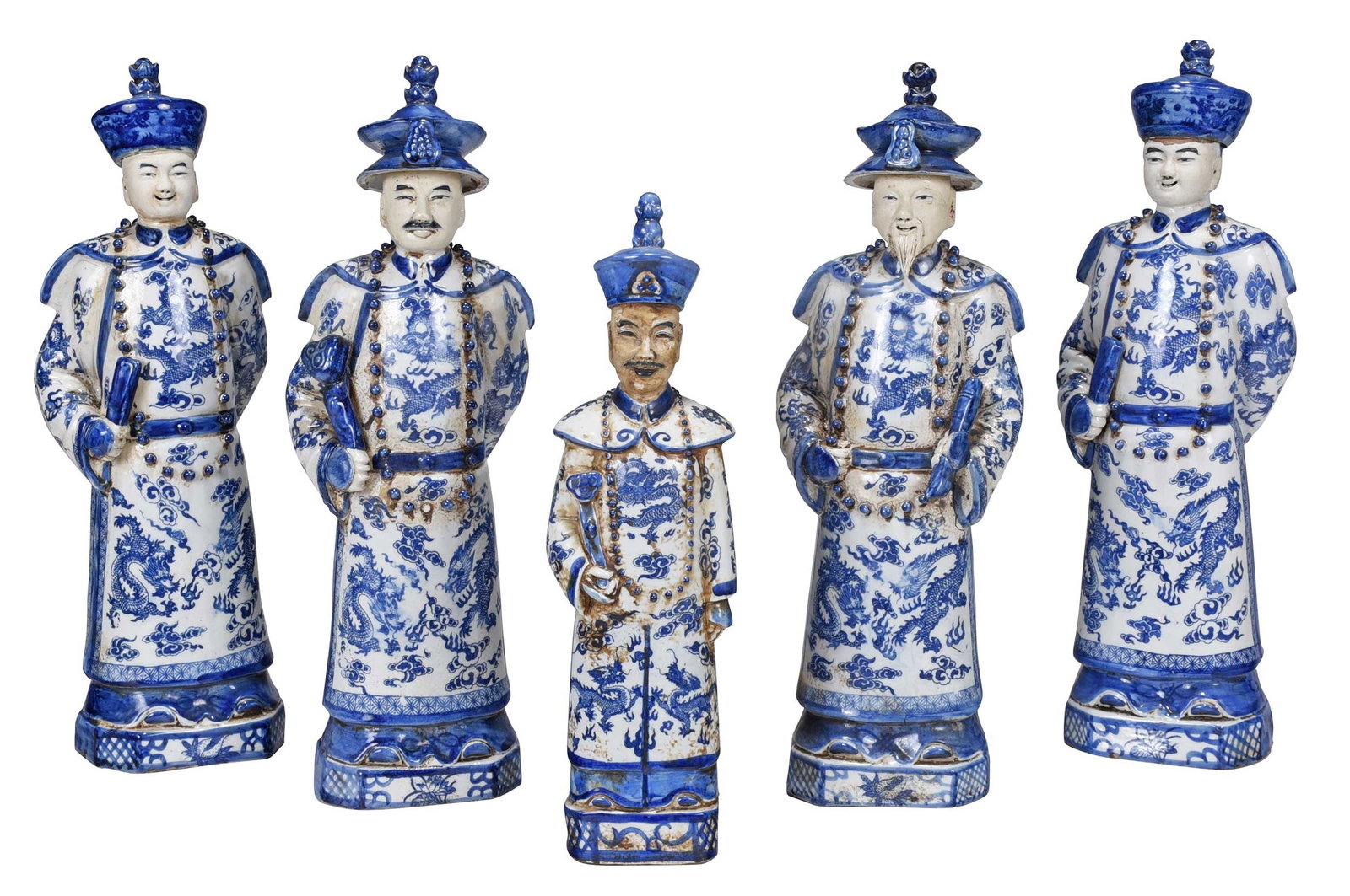 Five Chinese Blue and White Porcelain Figures with Two Cases: Qing dynasty, each with impressed illegible reign mark to base, in the form of five dignitaries/scholars adorned in dragon robes, beaded necklaces, and hats, 15 in. to 18 in.; two with covered acrylic