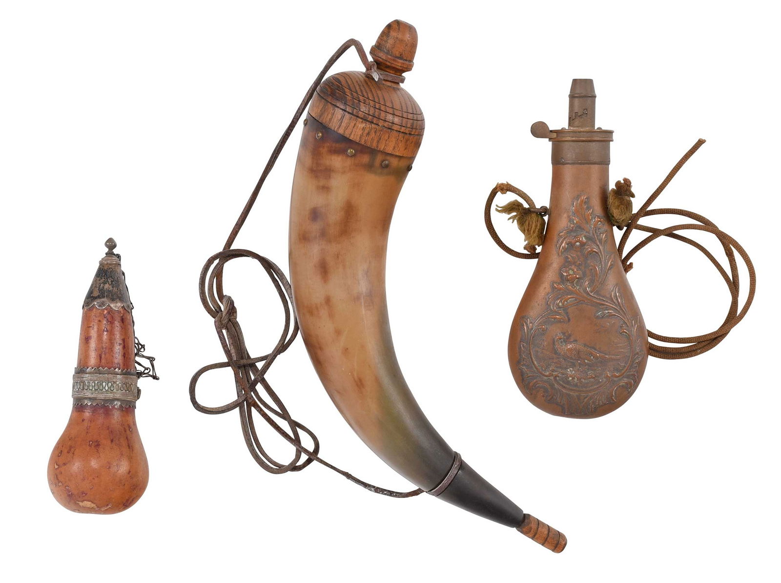 Group of Three Powder Horns/Flasks: Turkmen gourd powder flask, with metal decoration; brass Civil War era flask with pheasant detail; and traditional horn flask with plug and stopper; smallest 5-3/4 in. to largest 13 in. Provenance: Pr