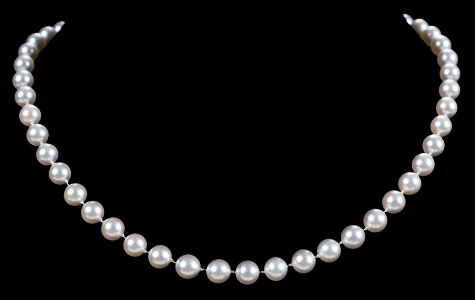 14kt. Mikimoto Strand of Pearls: 50 Mikimoto fine akoya pearls, 7.0 - 7.5mm, white color, rose overtone, single strand of individually knotted, stamped "K14 M", 14kt. yellow gold clasp with "M" maker's mark, 4.0mm pearl on clasp, len