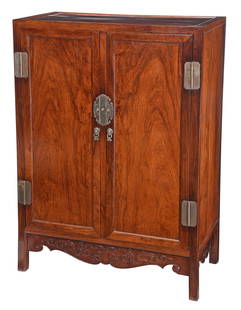 Chinese Paktong Mounted Huanghuali Cabinet: 19th century, paneled doors, center stile, interior fitted with shelves and two drawers, Paktong nickel copper alloy hardware, dragon carved serpentine skirt, molded legs, through tenon construction,