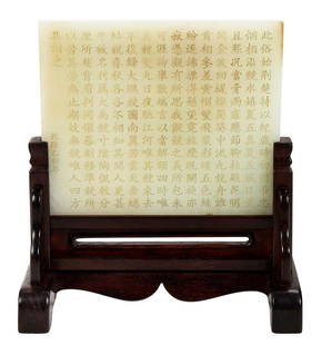 Chinese Carved Jade Plaque with Fitted Wood Stand: incised "Yimao year of Qianlong" (circa 1795), pale green with whitish inclusions, incised Chinese script, 3-1/2 x 4-1/4 x 1/4 in.; with conforming wood stand, on stand 5-1/4 x 5 x 2-3/4 in.Note: