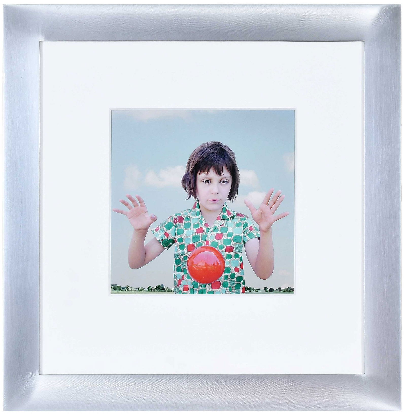 Loretta Lux: (German, born 1969) The Red Ball, 2000, signed, titled, dated, and editioned 13/20 print verso, Illfochrome print, image 9 x 8-3/4 in.; silver brushed metal frame, 19-1/4 x 19 in.
