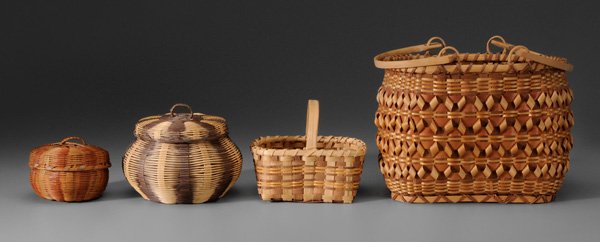Four Cherokee Baskets: oak split child's, Qualla tag for Martha Ross, walnut and bloodroot dyes, 5-1/2 in., [dyes faded;] lidded circular honeysuckle, 3-3/4 in.; lidded honeysuckle, Qualla tag for Lucy George, 5-3/4 in.; tw