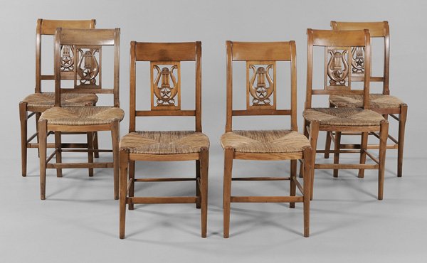 Set of Six [Directoire] Style: Fruitwood Dining Chairs French, 20th century, each with lyre and star carved back and rush seat, 35-1/2 x 17-1/2 x 21 in., minor sun fading, surface variation and wear, minor cracks to splats and seat