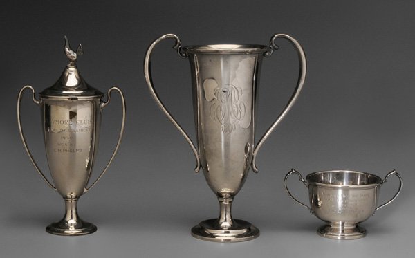 Three Sterling Trophies, Tiffany: American, 20th century, two-handled urn forms: one lidded with rooster finial, marks for Tiffany & Co., 1950 inscription, 8-7/8 in.; one with crest and 1900 inscription, marks for Black, Starr & Frost