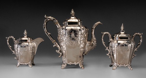 Gregg & Hayden Coin Silver Tea Service: American, 1849, paneled bodies, scroll handles, feet and finials, floral repoussé decoration, 11 in. teapot with matching creamer and covered sugar, marks for retailer Gregg, Hayden & Co. (Charleston