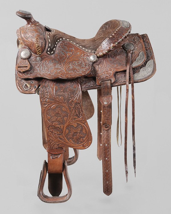 Ornate Leather Parade Saddle: probably mid 20th century, extensively tooled leather with silver mounts at corners and pommel, floral and leaf medallions throughout, back of saddle with open cartouche, excellent condition, shows on