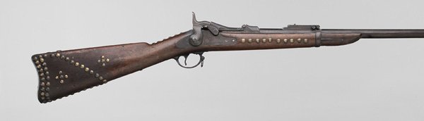 U.S. Springfield Trapdoor Rifle: 24 in. barrel, trapdoor marked "US/Model/1878", serial number 33295", lockplate marked "US Springfield" with an eagle, extensive brass tack decoration, "RHB" carved in block on stock, Buffington sight