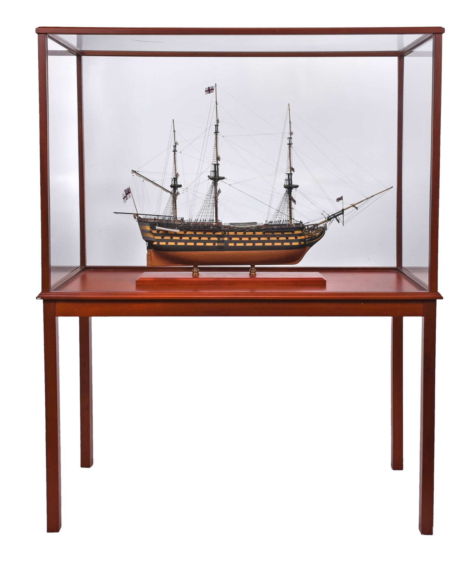 HMS Victory Ship Model in Table Top Case: 20th century, titled "Victory", 12 sails and three British flags, painted wood construction with string, cloth, and wire elements, finely detailed, mounted on wood and brass stand, overall 29-1/2 x 37