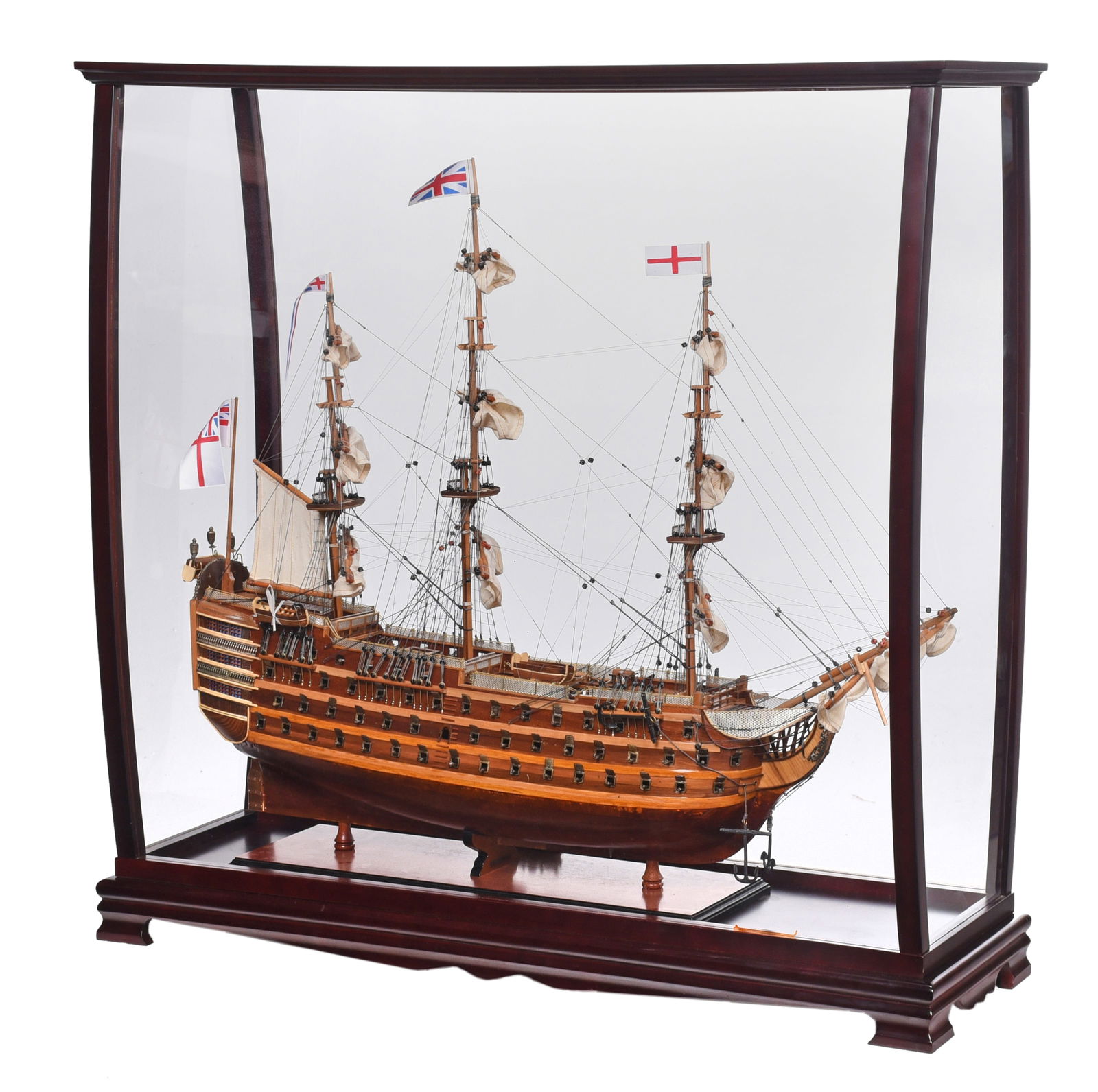 HMS Victory Ship Model in Floor Case: 20th century, titled "HMS Victory 1776", large triple deck three masted ship with 12 sails and four British flags, wood construction with assorted wire, cloth, and metal elements, finely detailed and