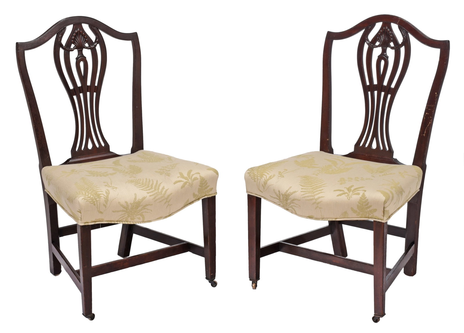 Pair of George III Carved Mahogany Side Chairs: probably British, circa 1800, each with carved and pierced splat, over the rail upholstered serpentine seats on tapered square legs with stretchers, set on casters, fern and leaf decorated upholstery,